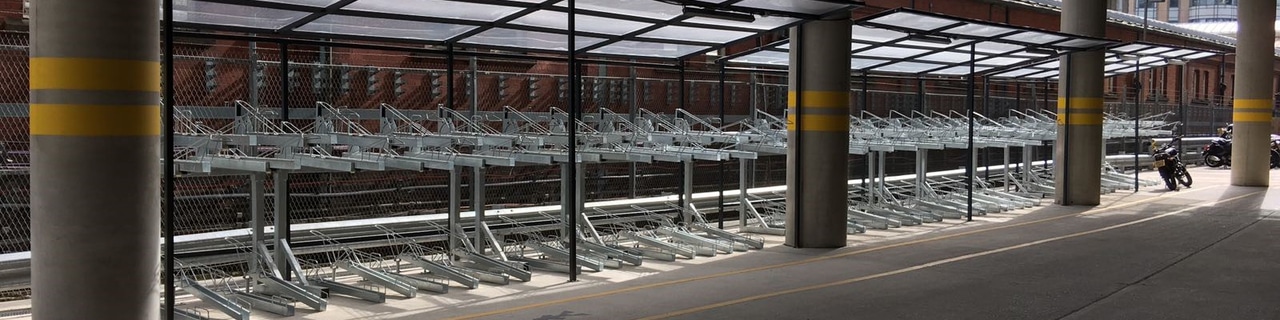 Bike Dock Solutions Two Tier Bike Racks installed at a public train station for commuters